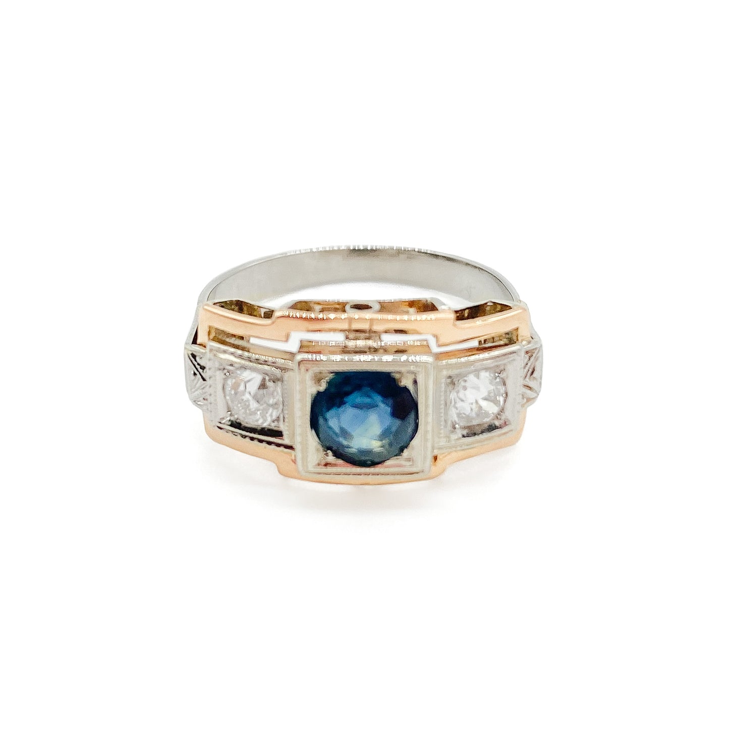 Stylish Art Deco 14ct white and rose gold ring set with a centre 0.50ct sapphire, and a 0.15ct diamond on each side. Lovey engraving on the shoulders. Italy