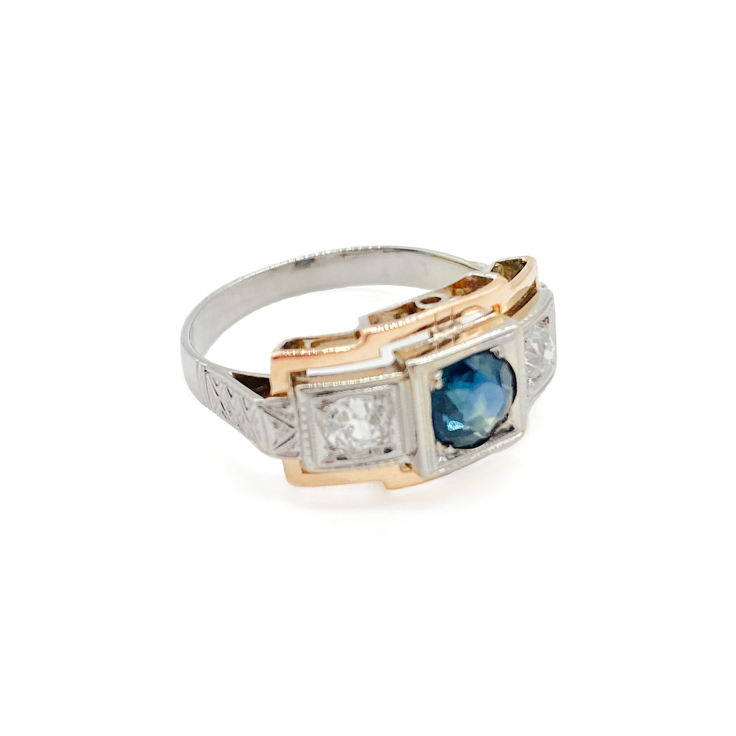 Stylish Art Deco 14ct white and rose gold ring set with a centre 0.50ct sapphire, and a 0.15ct diamond on each side. Lovey engraving on the shoulders. Italy