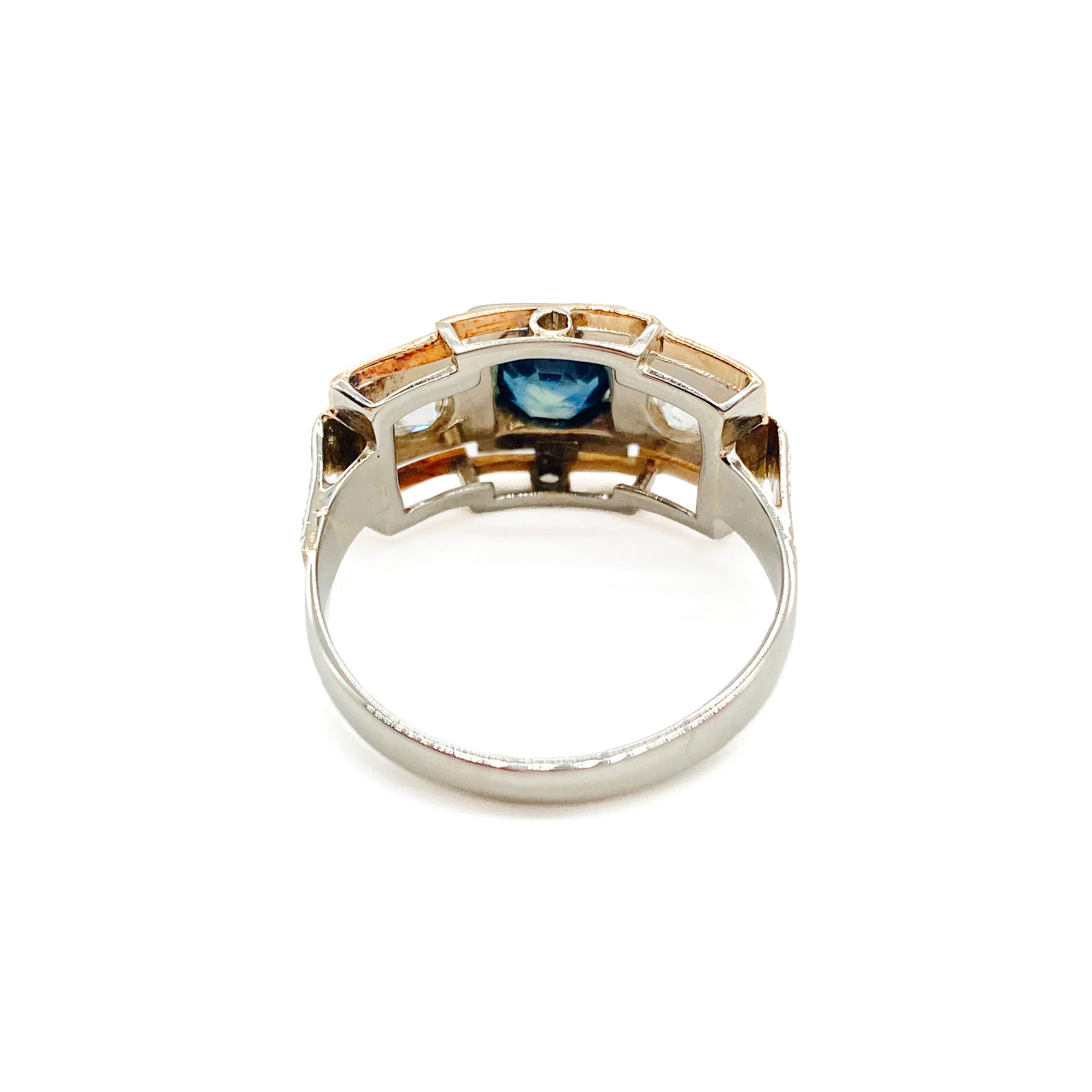 Stylish Art Deco 14ct white and rose gold ring set with a centre 0.50ct sapphire, and a 0.15ct diamond on each side. Lovey engraving on the shoulders. Italy