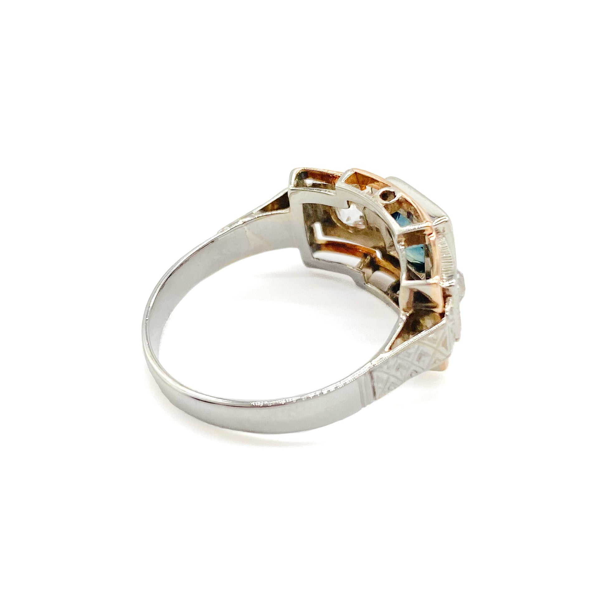 Stylish Art Deco 14ct white and rose gold ring set with a centre 0.50ct sapphire, and a 0.15ct diamond on each side. Lovey engraving on the shoulders. Italy