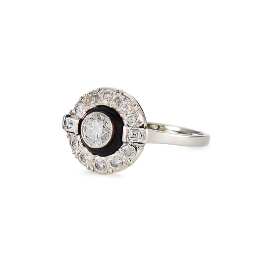 Classic Art Deco 14ct white gold ring, with a 0.50ct tube set old cut diamond, surrounded by a black enamel collar and ten smaller diamonds, flanked by two baguette diamonds.