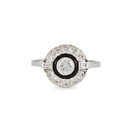 Classic Art Deco 14ct white gold ring, with a 0.50ct tube set old cut diamond, surrounded by a black enamel collar and ten smaller diamonds, flanked by two baguette diamonds.