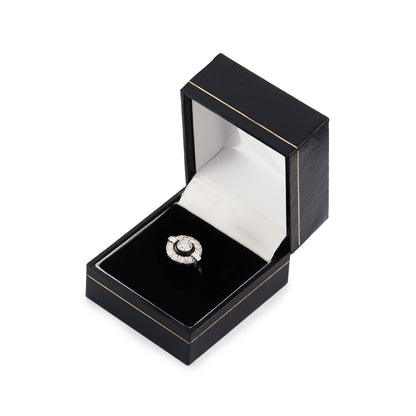 Classic Art Deco 14ct white gold ring, with a 0.50ct tube set old cut diamond, surrounded by a black enamel collar and ten smaller diamonds, flanked by two baguette diamonds.