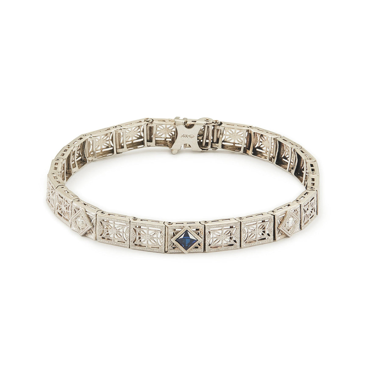 Elegant Art Deco 14ct white gold filigree bracelet set with two round, natural diamonds and a deep-blue sapphire.