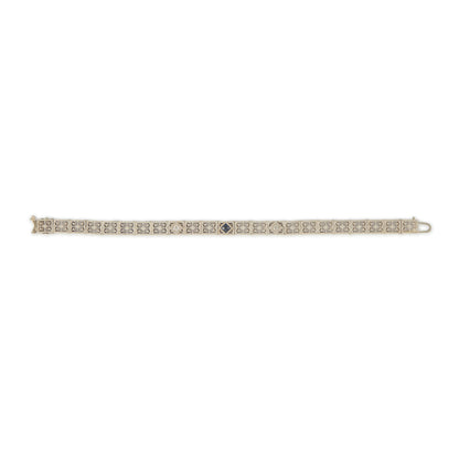 Elegant Art Deco 14ct white gold filigree bracelet set with two round, natural diamonds and a deep-blue sapphire.