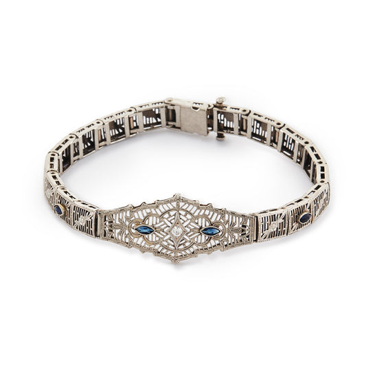 Intricate Art Deco filigree 14ct white gold bracelet set with four marquise sapphires and a round 0,10ct diamond in the centre.