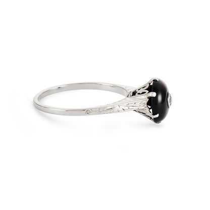 Stylish 14ct white gold Art Deco ring, set with a round cabochon onyx embellished with a small diamond. Beautiful engraving on shoulder of ring.