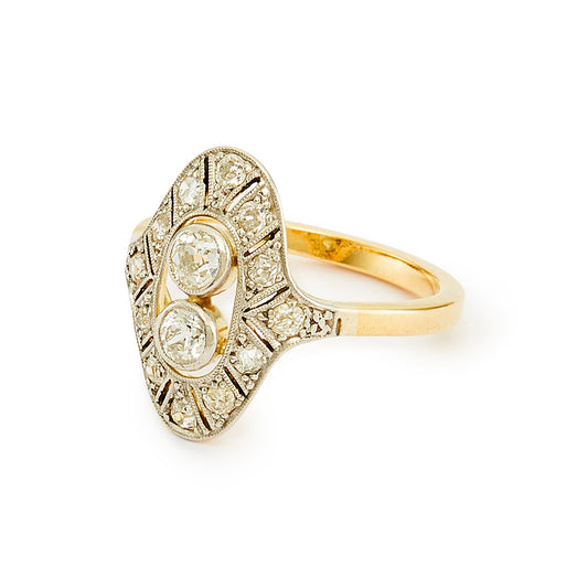 Stunning Art Deco ring with two centre, natural, old-cut diamonds, surrounded by twelve smaller old cut diamonds in an intricate 18ct white gold milgrain setting, with an 18ct yellow gold shank.