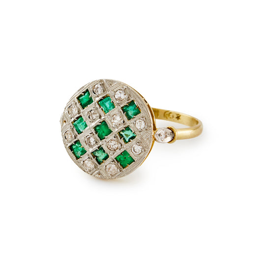 Classic 18ct gold Art Deco ring with fourteen small diamonds and nine square emeralds in a platinum setting.