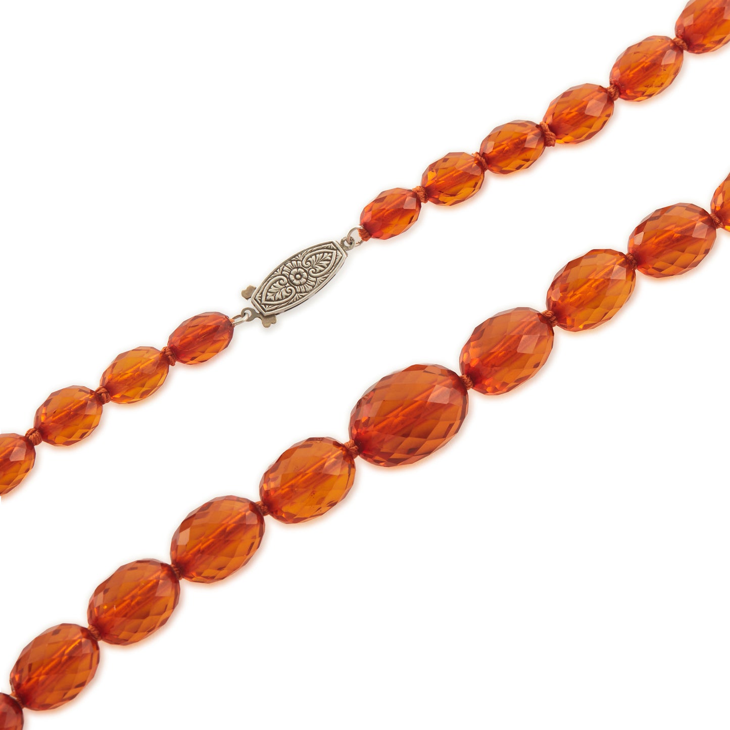 Beautifully faceted Art Deco Baltic amber necklace with an engraved silver clasp. The graduated amber beads have very sought after varied natural cognac hues.