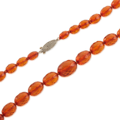 Beautifully faceted Art Deco Baltic amber necklace with an engraved silver clasp. The graduated amber beads have very sought after varied natural cognac hues.
