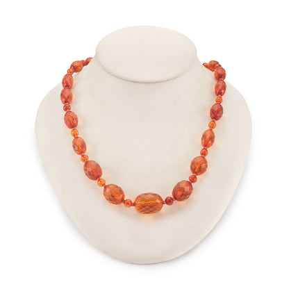 Beautifully faceted Art Deco Baltic amber necklace with an engraved silver clasp. The graduated amber beads have very sought after, varied natural cognac hues.