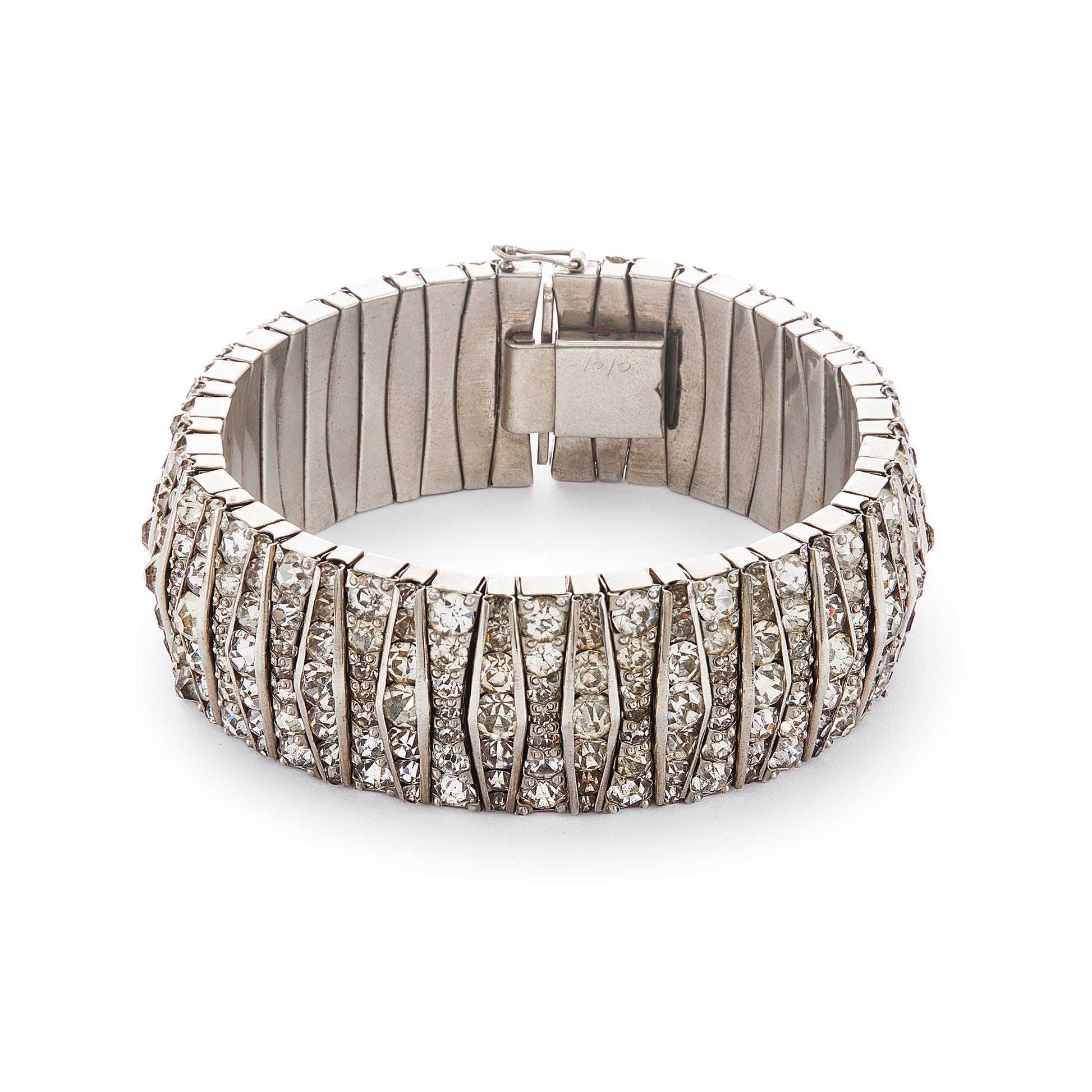 Glamorous articulated Art Deco metal bracelet set with an abundance of paste stones in varying shades of white.