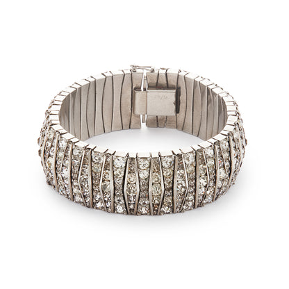 Glamorous articulated Art Deco metal bracelet set with an abundance of paste stones in varying shades of white.