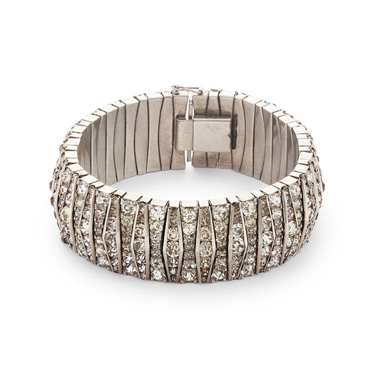 Glamorous articulated Art Deco metal bracelet set with an abundance of paste stones in varying shades of white.