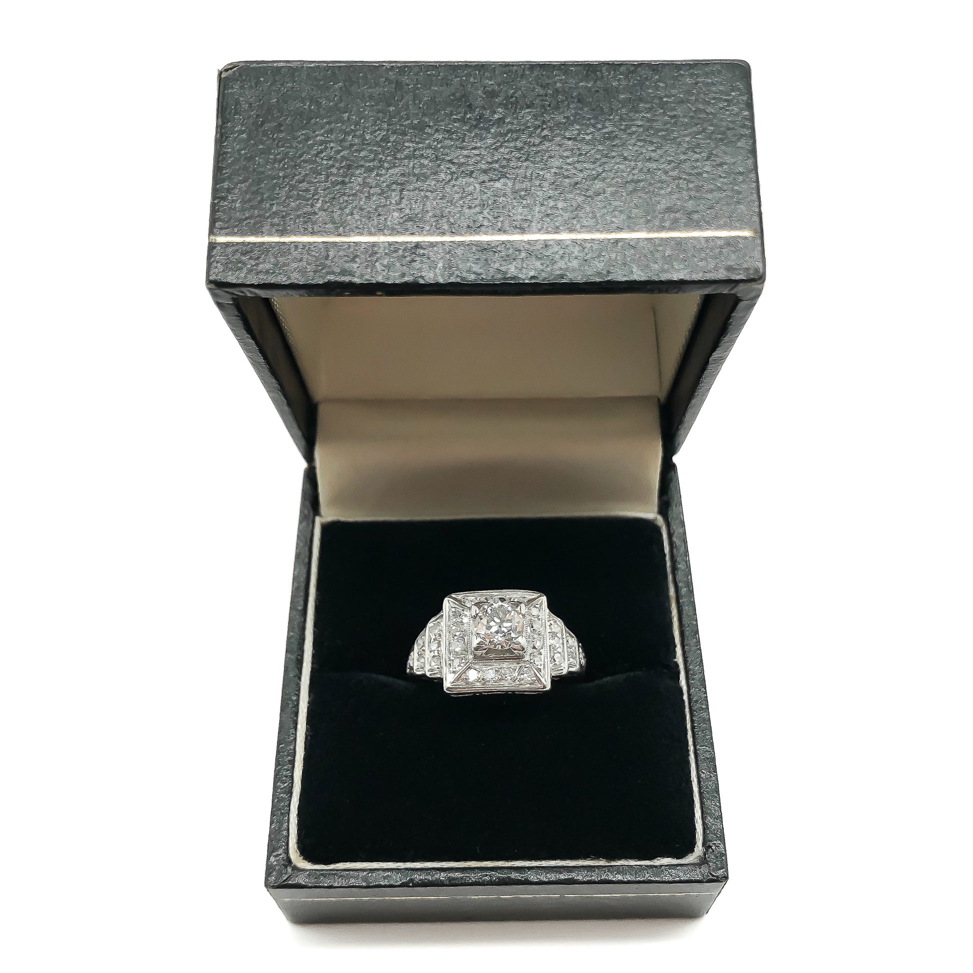 Stylish Art Deco platinum diamond ring set with a 0.50ct centre diamond, surrounded by twenty-eight smaller old-cut diamonds.