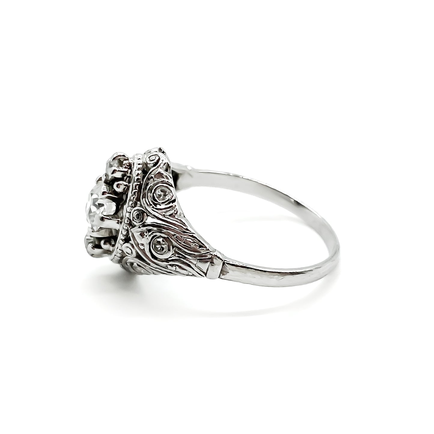 Pretty Art Deco platinum ring set with three centre diamonds and three small diamonds on each shoulder, complemented with beautiful filigree detail.