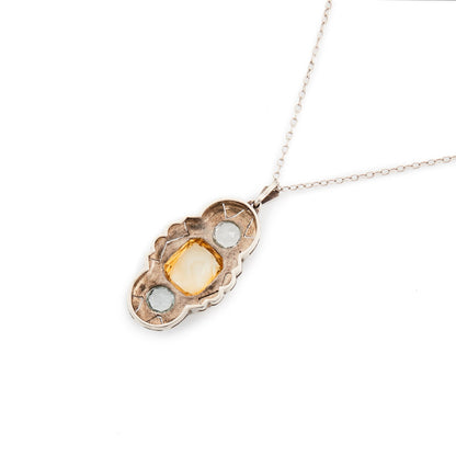 Lovely silver Art Deco Fahner-style pendant set with a single citrine and two faceted aquamarines, on a silver chain.