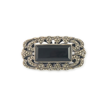 Stylish Art Deco sterling silver marcasite brooch set with a rectangular black onyx stone. Safety clasp.