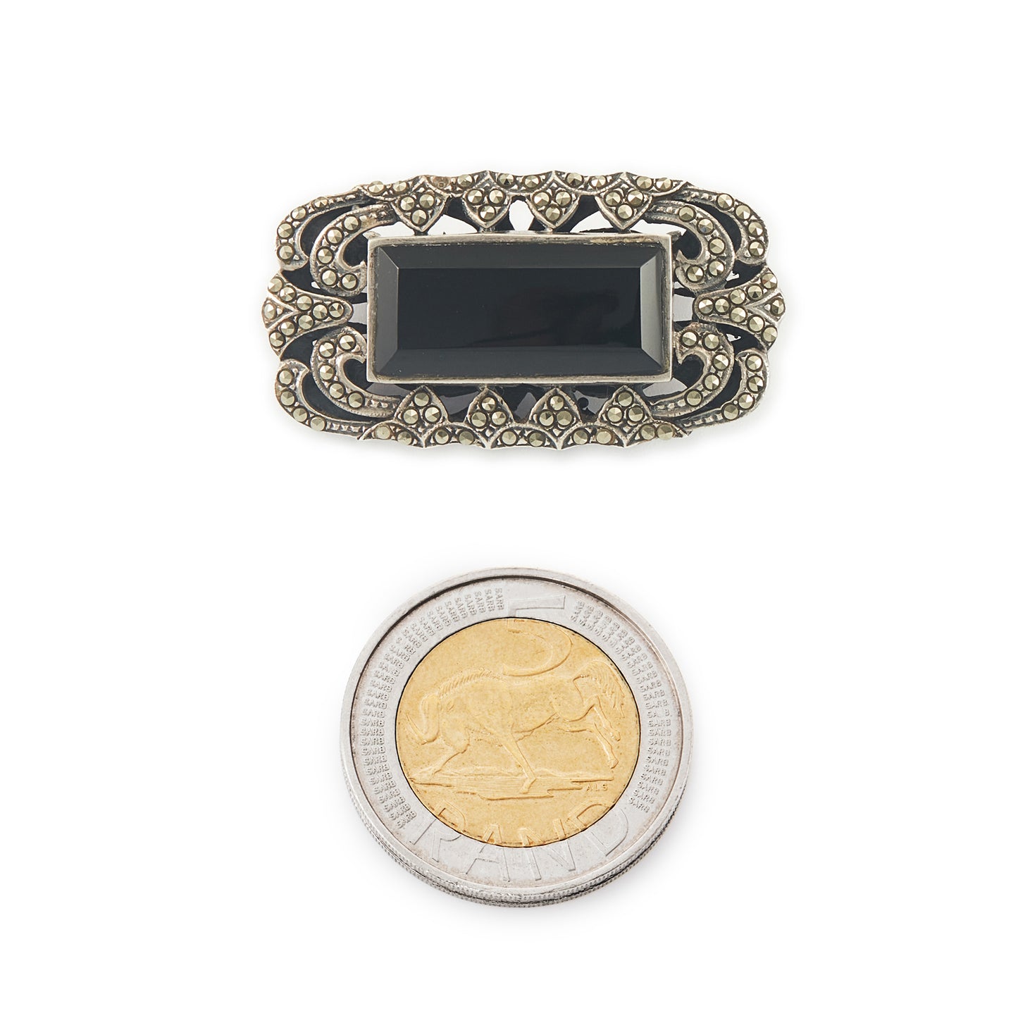 Stylish Art Deco sterling silver marcasite brooch set with a rectangular black onyx stone. Safety clasp.