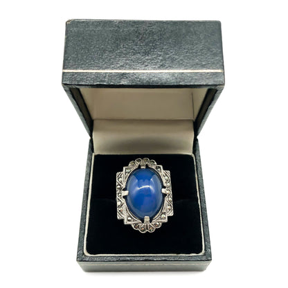 Beautiful Art Deco sterling silver ring set with a blue chalcedony oval cabochon, in a marcasite frame.