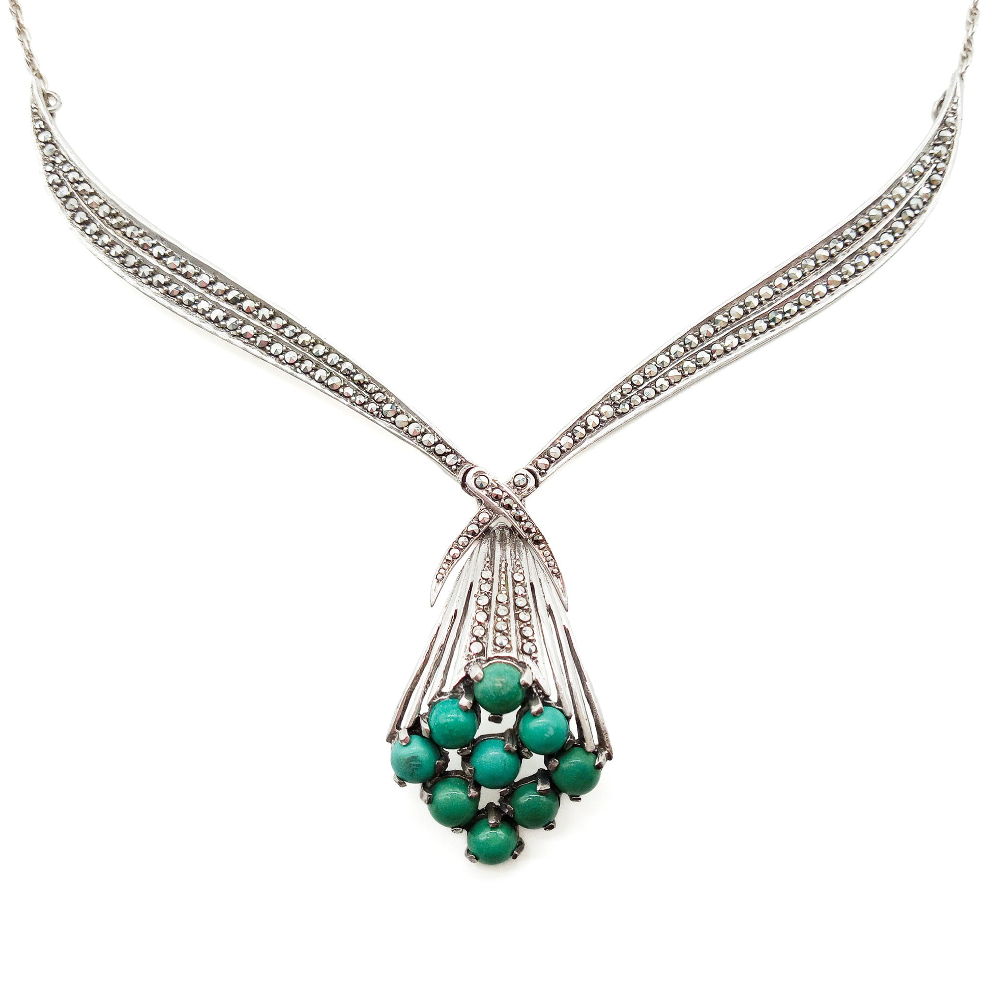 Stunning Art Deco sterling silver necklace set with nine natural turquoise stones and a meleé of marcasites on a rope chain.