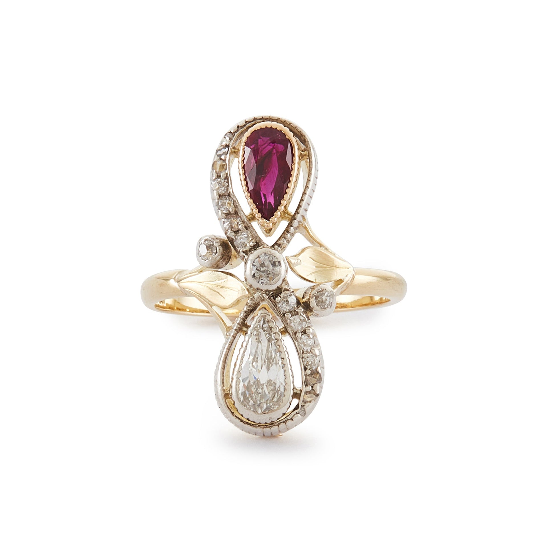 Magnificent Art Nouveau ring set with a pear-shaped ruby and an old-cut, pear-shaped diamond, surrounded by sixteen smaller old-cuts. A finely crafted leaf sits on either side of the centre diamond.