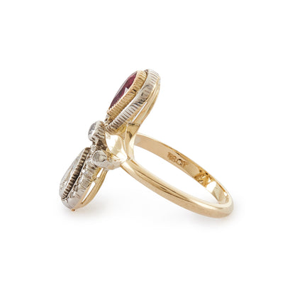 Magnificent Art Nouveau ring set with a pear-shaped ruby and an old-cut, pear-shaped diamond, surrounded by sixteen smaller old-cuts. A finely crafted leaf sits on either side of the centre diamond.