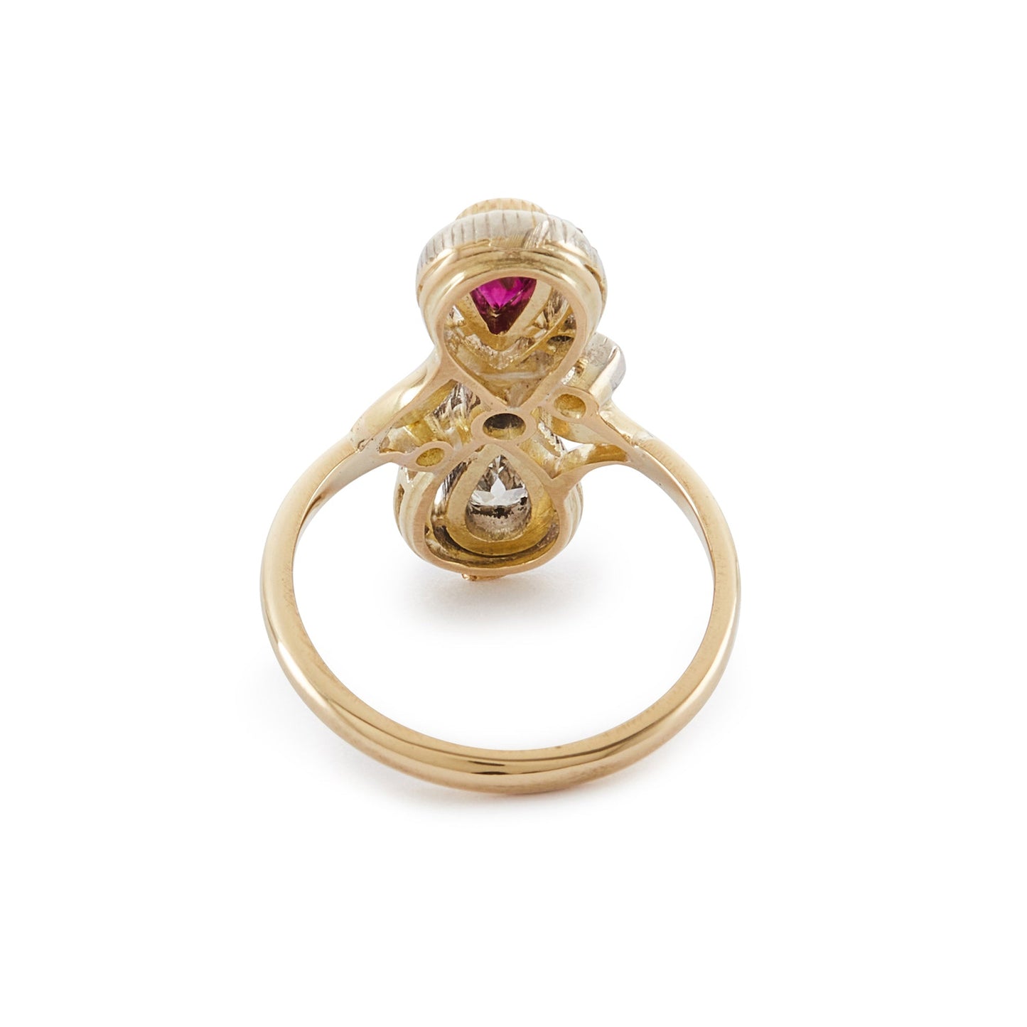 Magnificent Art Nouveau ring set with a pear-shaped ruby and an old-cut, pear-shaped diamond, surrounded by sixteen smaller old-cuts. A finely crafted leaf sits on either side of the centre diamond.