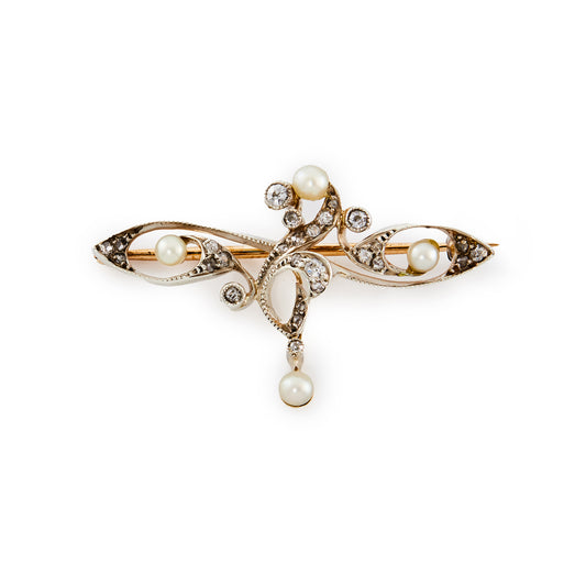 Delicate rose gold and silver Art Nouveau brooch set with old cut diamonds and four small pearls in a free flowing design, with a small diamond and pearl drop.