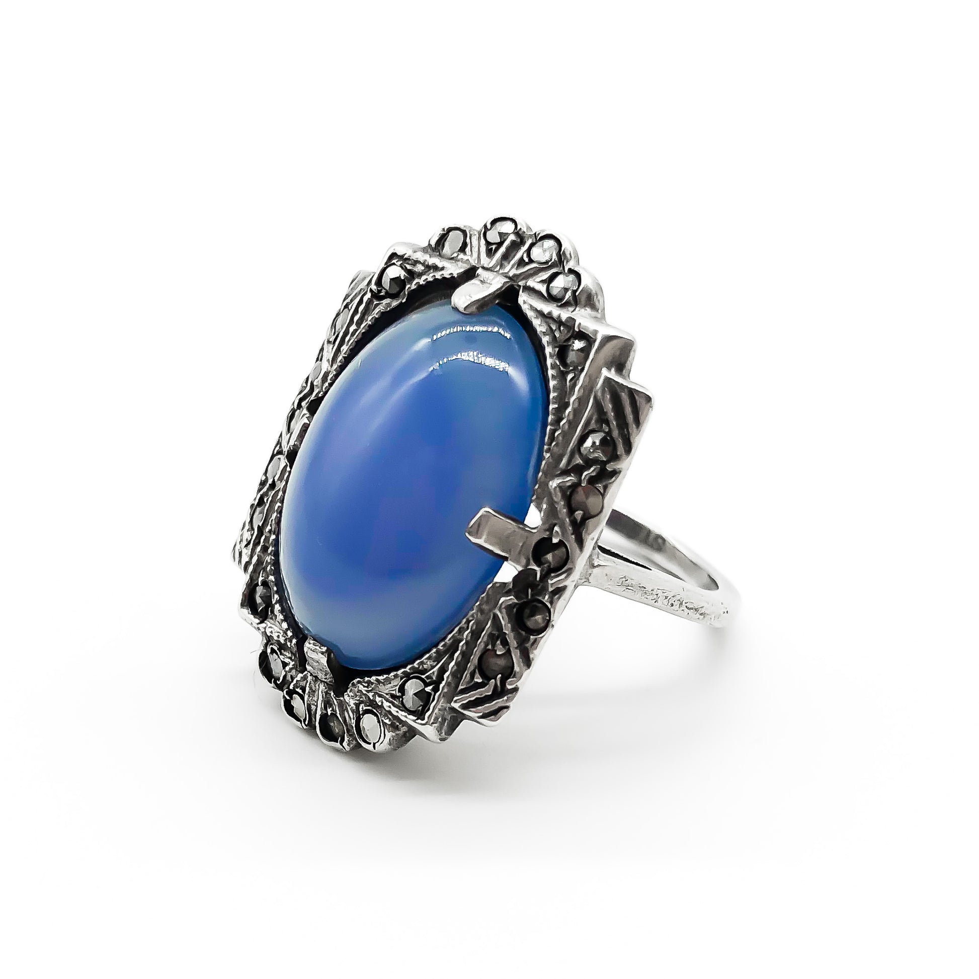 Beautiful Art Deco sterling silver ring set with a blue chalcedony oval cabochon, in a marcasite frame.