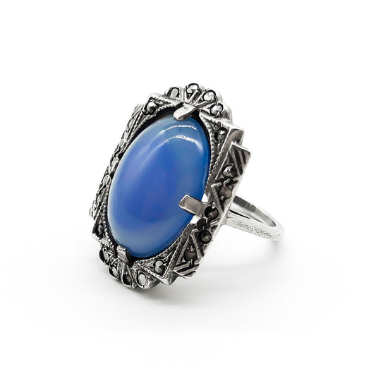 Beautiful Art Deco sterling silver ring set with a blue chalcedony oval cabochon, in a marcasite frame.