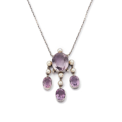 Beautiful Arts and Crafts silver necklace set with four chunky purple faceted amethysts, seven lustrous pearls and four tiny mine-cut diamonds. The necklace has a lovely toggle clasp.