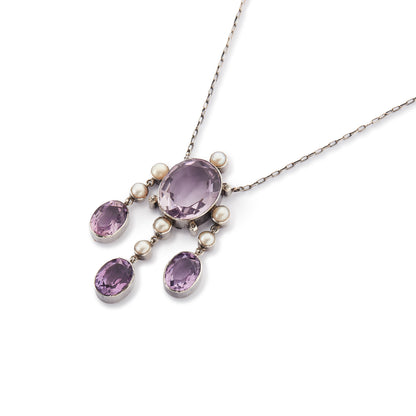 Beautiful Arts and Crafts silver necklace set with four chunky purple faceted amethysts, seven lustrous pearls and four tiny mine-cut diamonds. The necklace has a lovely toggle clasp.