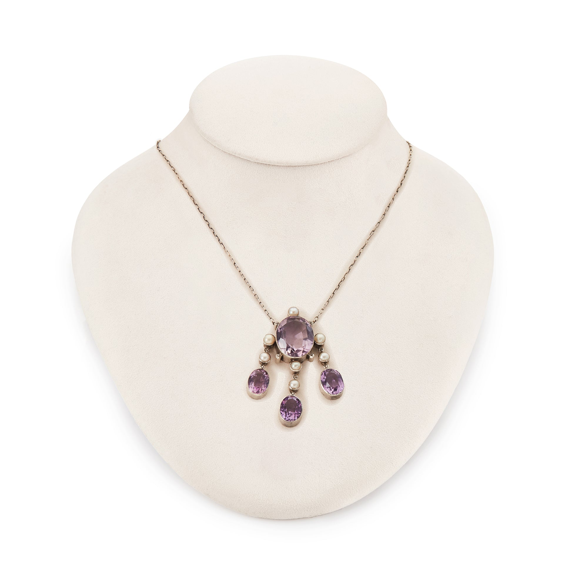 Beautiful Arts and Crafts silver necklace set with four chunky purple faceted amethysts, seven lustrous pearls and four tiny mine-cut diamonds. The necklace has a lovely toggle clasp.