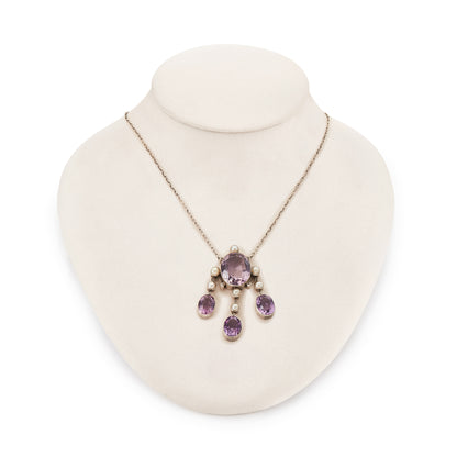Beautiful Arts and Crafts silver necklace set with four chunky purple faceted amethysts, seven lustrous pearls and four tiny mine-cut diamonds. The necklace has a lovely toggle clasp.