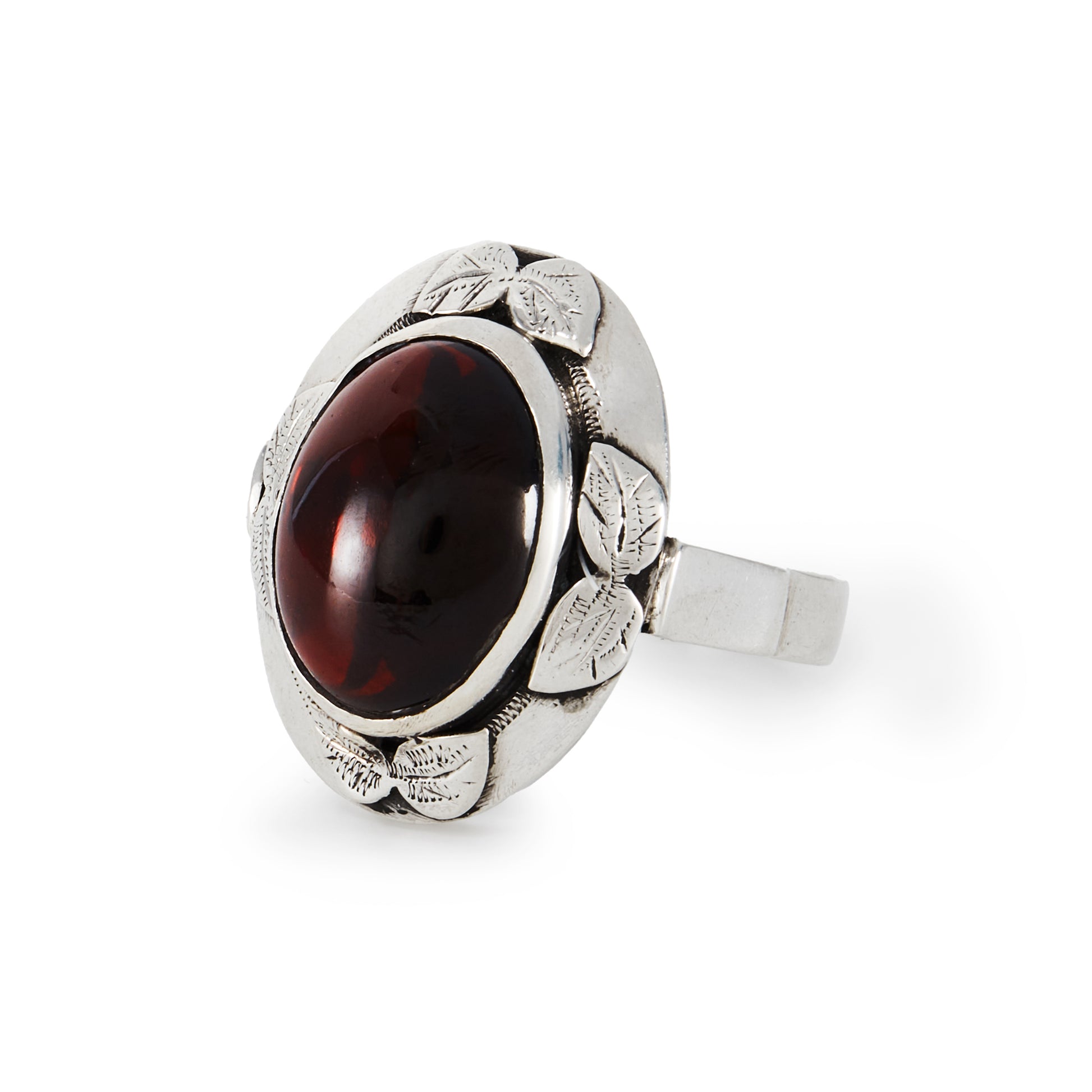 Lovely silver Arts and Crafts ring, set with a deep red oval cabochon garnet in an engraved leaf setting.