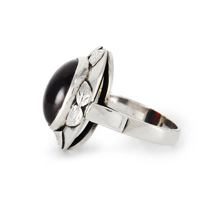 Lovely silver Arts and Crafts ring, set with a deep red oval cabochon garnet in an engraved leaf setting.
