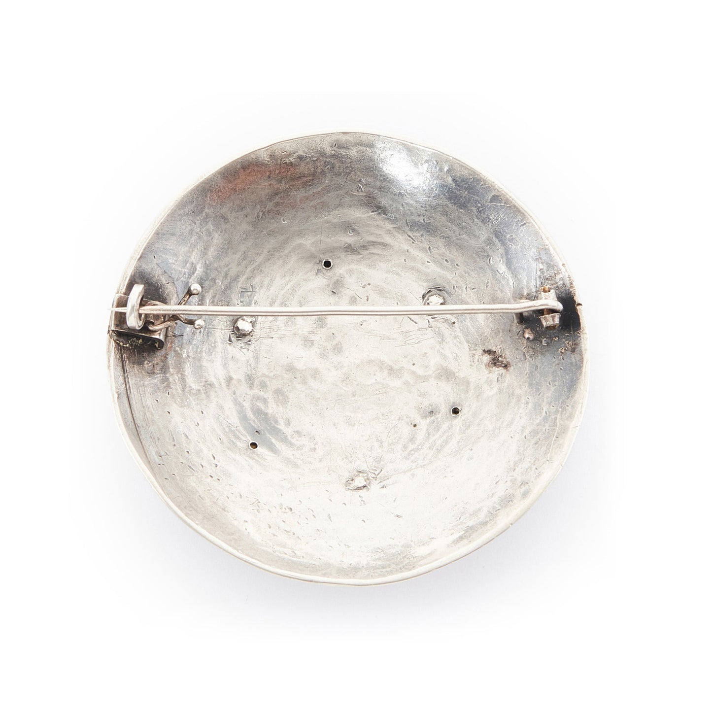 Large hand-beaten silver Arts and Crafts brooch set with a Mother of Pearl disc in the centre, surrounded by three coral beads and a repoussé design.