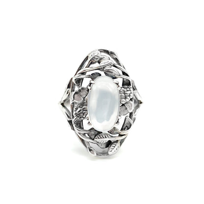 Gorgeous Arts and Crafts silver ring set with an oval cabochon moonstone in an ornate leaf setting.