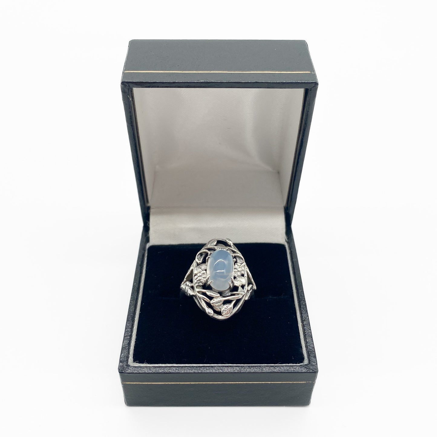 Gorgeous Arts and Crafts silver ring set with an oval cabochon moonstone in an ornate leaf setting.