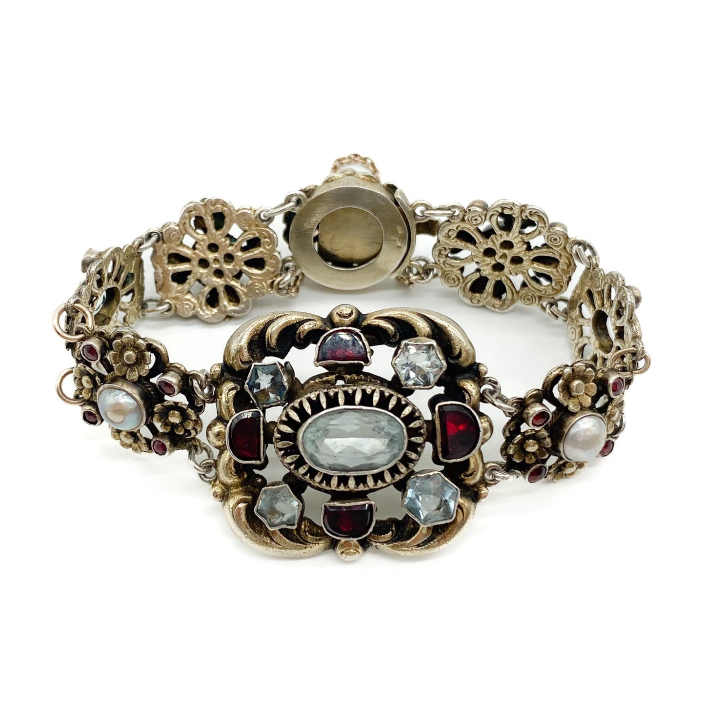 Stunning silver gilt Austro-Hungarian bracelet set with eight faceted aquamarines, twenty six garnets and four half pearls. Safety chain attached. Circa 1900’s