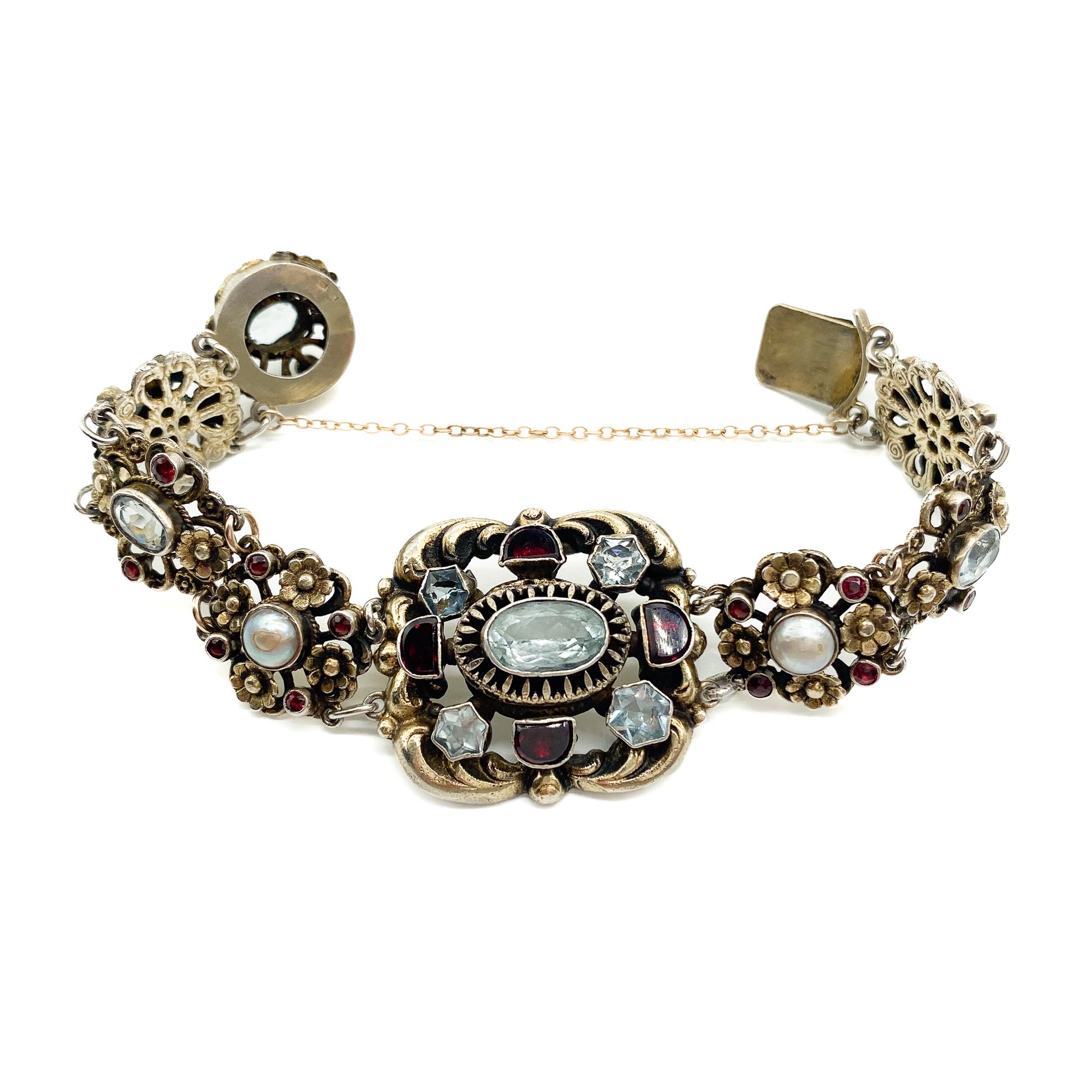 Stunning silver gilt Austro-Hungarian bracelet set with eight faceted aquamarines, twenty six garnets and four half pearls. Safety chain attached. Circa 1900’s