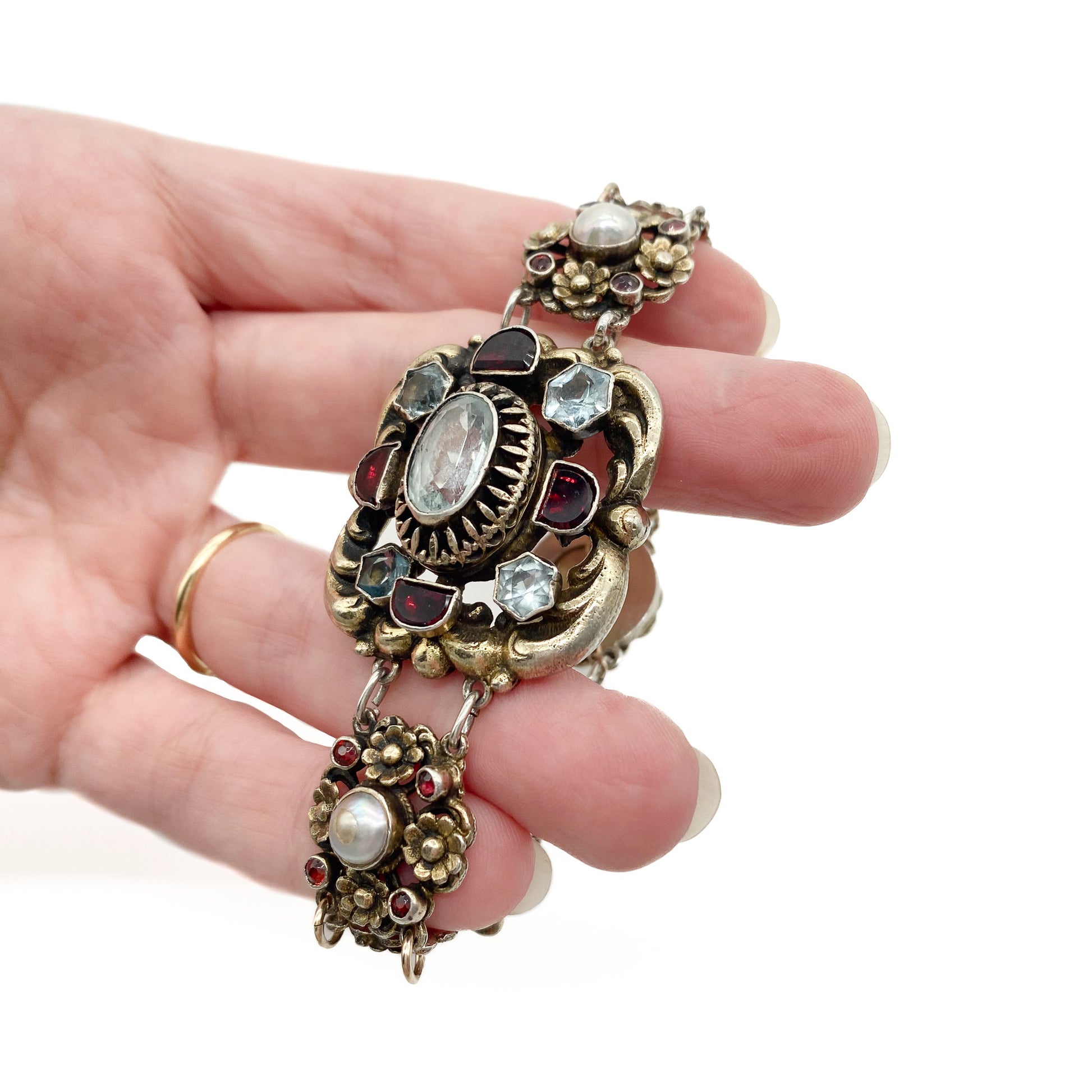 Stunning silver gilt Austro-Hungarian bracelet set with eight faceted aquamarines, twenty six garnets and four half pearls. Safety chain attached. Circa 1900’s