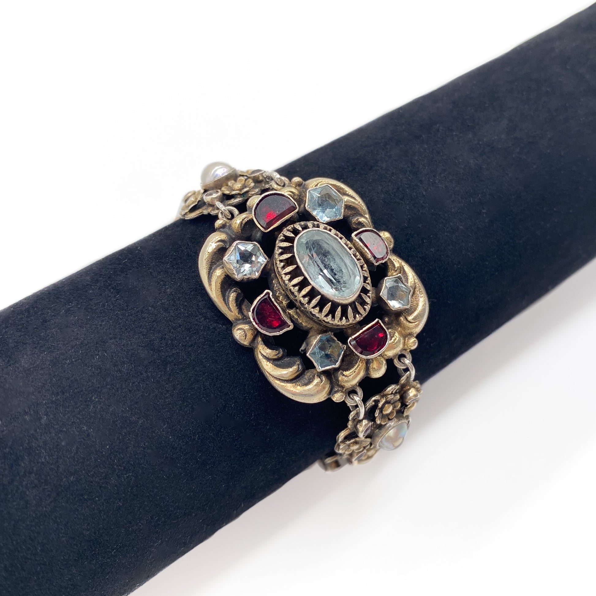 Stunning silver gilt Austro-Hungarian bracelet set with eight faceted aquamarines, twenty six garnets and four half pearls. Safety chain attached. Circa 1900’s