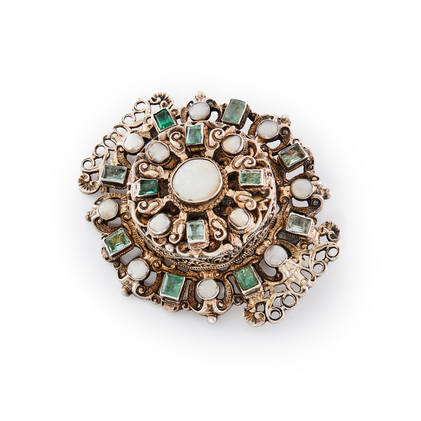 Magnificent Austro-Hungarian silver gilt brooch with a very unusual hidden compartment, set with twelve rough cut emeralds and thirteen pearl/mother of pearl discs. Beautiful filigree detail. Later brooch fitting. Circa 1890