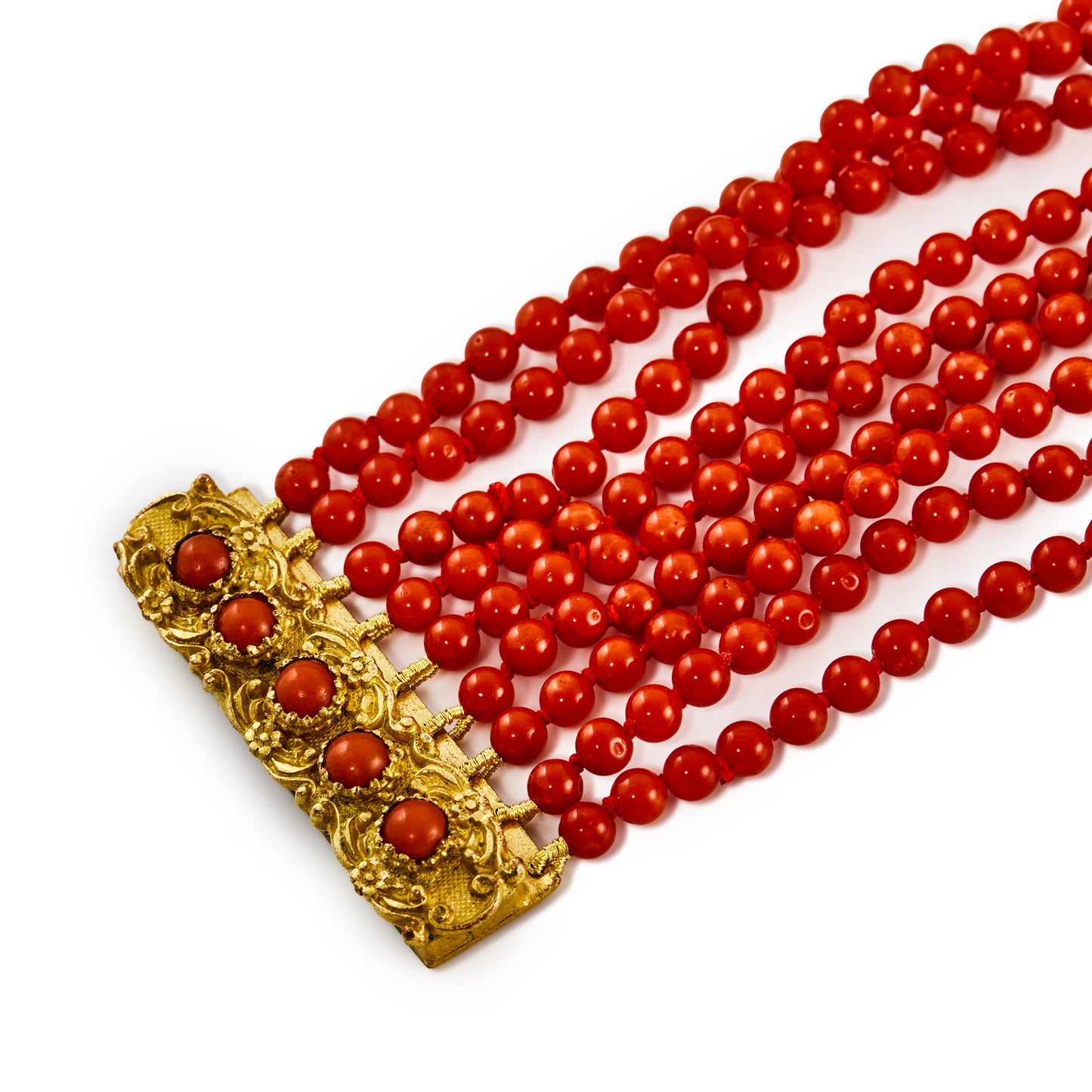 Striking nine-strand natural, vibrant red Mediterranean coral bracelet with a Victorian ormolu clasp, set with five cabochon coral beads.