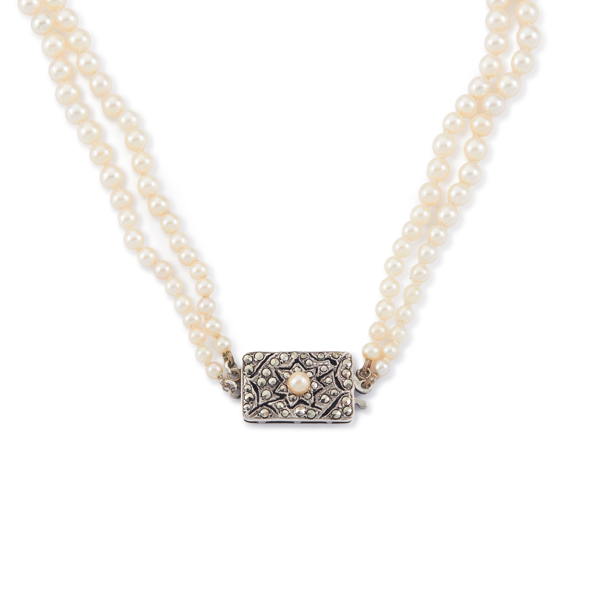 Beautiful pearl necklace consisting of two strands of creamy graduated seawater pearls, finished with a stunning vintage sterling silver, marcasite and seed pearl clasp. The pearls have a lovely lustre.