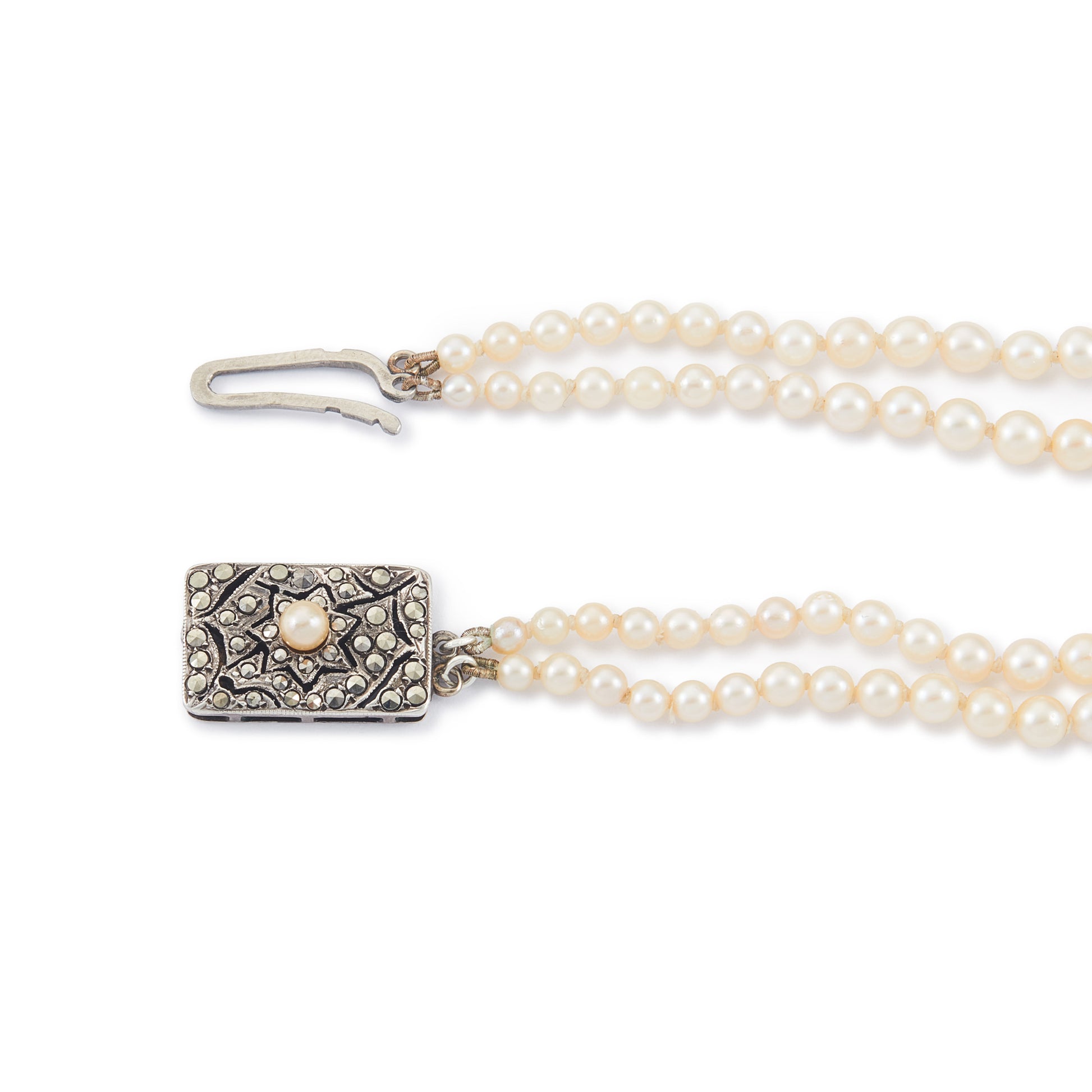 Beautiful pearl necklace consisting of two strands of creamy graduated seawater pearls, finished with a stunning vintage sterling silver, marcasite and seed pearl clasp. The pearls have a lovely lustre.