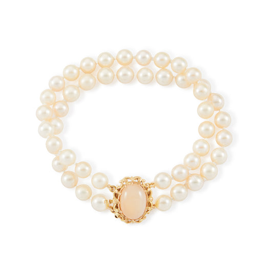 Lovely double strand bracelet consisting of lustrous cultured seawater pearls attached to a 9ct yellow gold and milky chalcedony clasp.